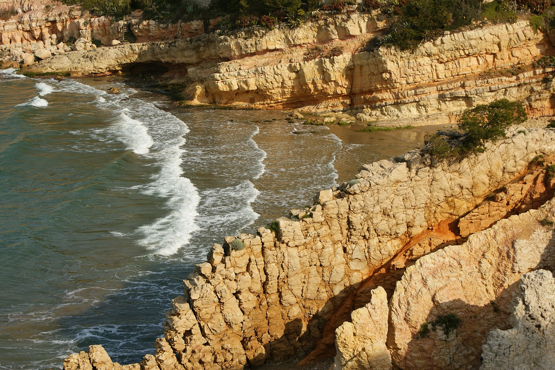 Cala Penya Tallada, among rocks and pines, at Cap de Salou